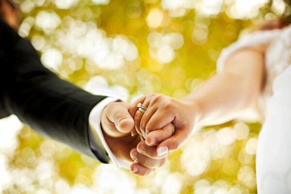 A close up of two people holding hands